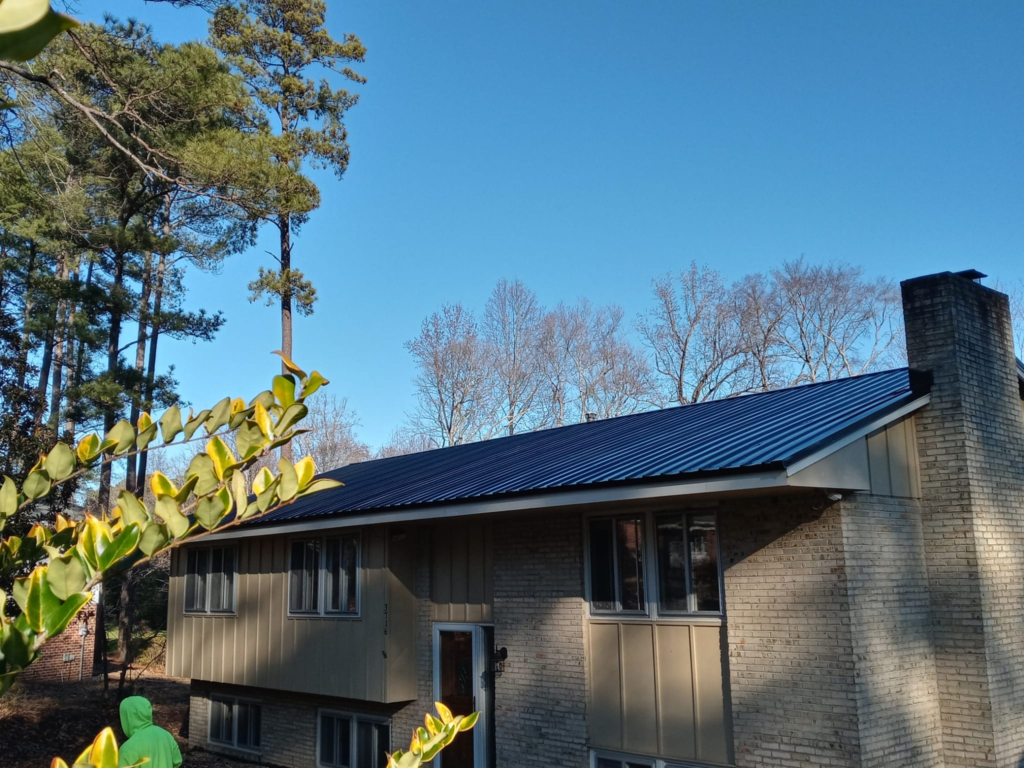 An image of a house with a blue metal roof